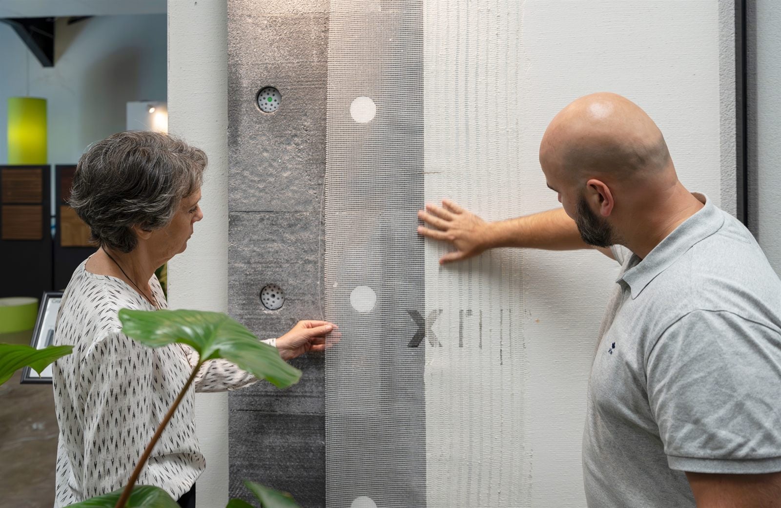Cralux-adviseur toont gevelmaterialen aan een klant in de showroom